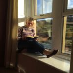 A guest reading a book at The Garsdale Retreat